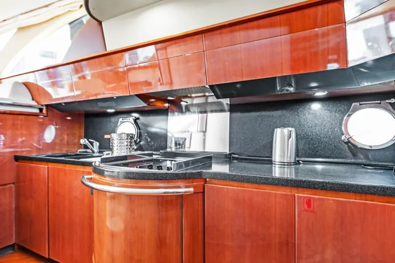 Slide: The Image of Luxurious 2006 Azimut Fly yacht kitchen with sleek wood cabinetry and modern appliances. - 25