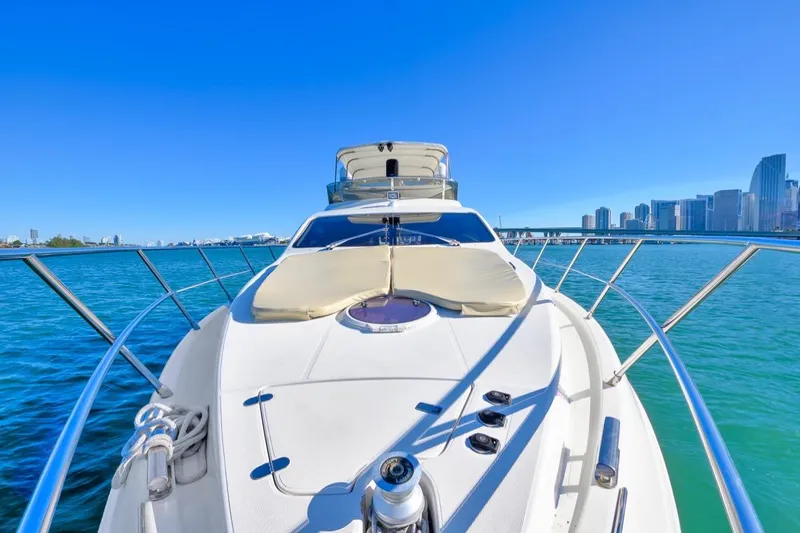 Slide: The Image of 2006 Azimut Fly yacht cruising near city skyline on a sunny day. - 8