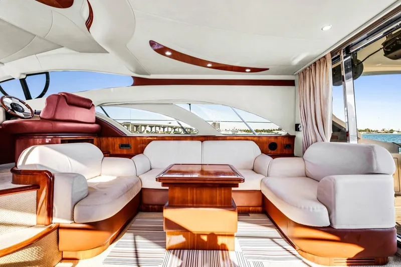 Slide: The Image of Luxurious interior of a 2006 Azimut Fly yacht with elegant seating and wooden accents. - 9