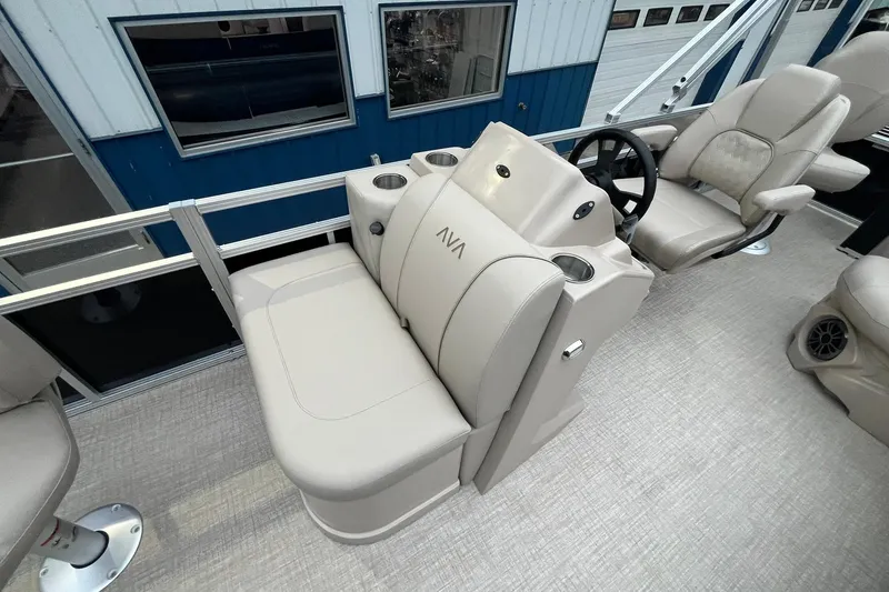 Slide: The Image of 2026 Avalon VTX Quad Fish boat interior with beige seating and steering console. - 10