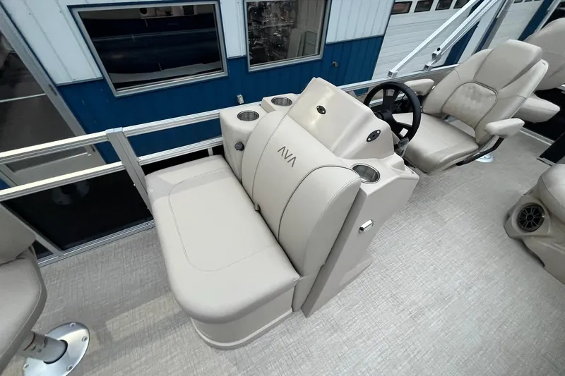 Slide: The Image of Interior of 2026 Avalon VTX Quad Fish boat with beige seating and steering console. - 11