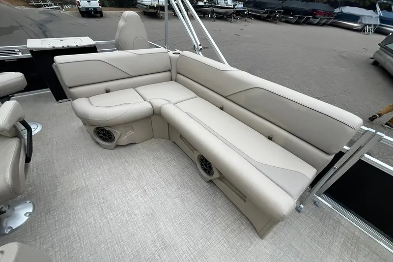 Slide: The Image of Luxurious seating on 2026 Avalon VTX Quad Fish boat, featuring beige upholstery and integrated speakers. - 13
