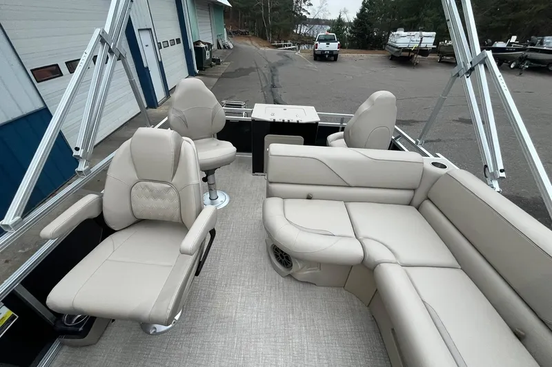 Slide: The Image of Luxurious interior of 2026 Avalon VTX Quad Fish pontoon boat with beige seating. - 14