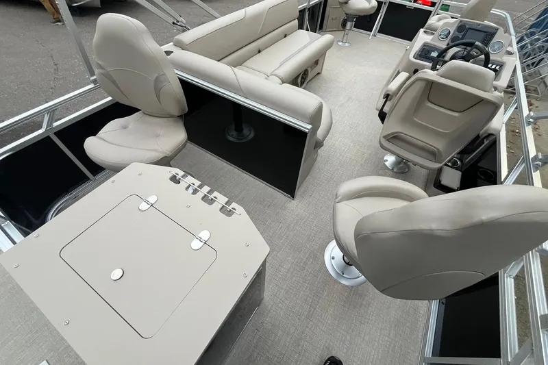 Slide: The Image of 2026 Avalon VTX Quad Fish boat interior with beige seating and modern dashboard. - 16