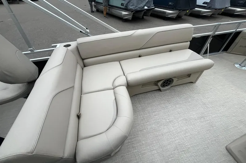 Slide: The Image of Luxurious seating on 2026 Avalon VTX Quad Fish pontoon boat, featuring beige upholstery and integrated speaker. - 20