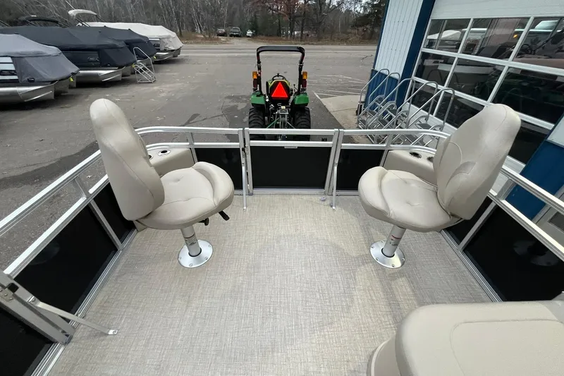 Slide: The Image of 2026 Avalon VTX Quad Fish boat interior with swivel seats and outdoor view. - 21