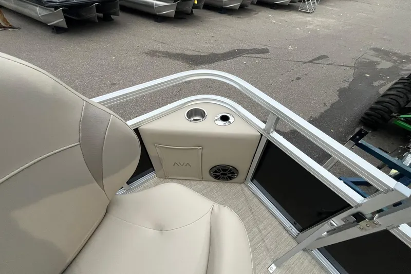 Slide: The Image of 2026 Avalon VTX Quad Fish boat interior with beige seating and cup holders. - 23