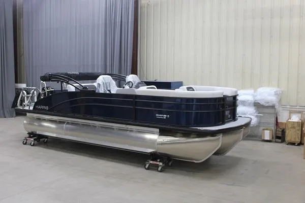 The Image of 2026 Harris Cruiser 210 pontoon boat in a warehouse setting. - 1