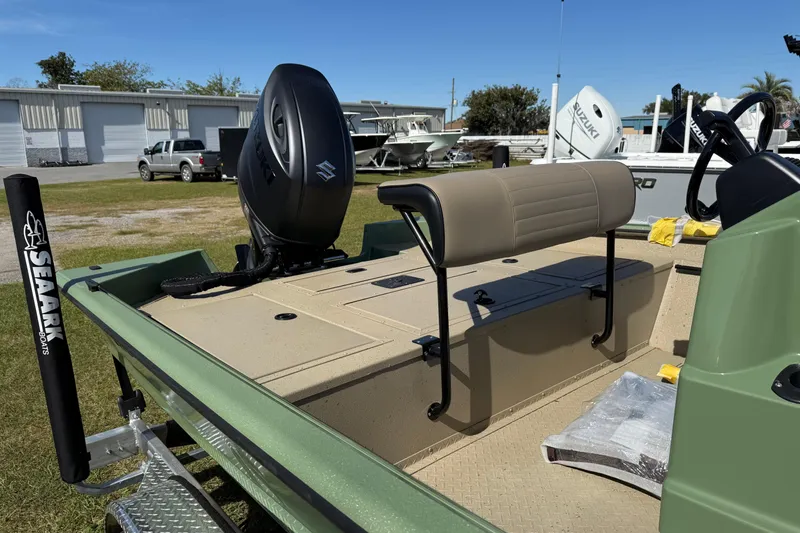 Slide: The Image of 2025 SeaArk Phantom 20XV boat with Suzuki outboard motor, parked outdoors. - 3