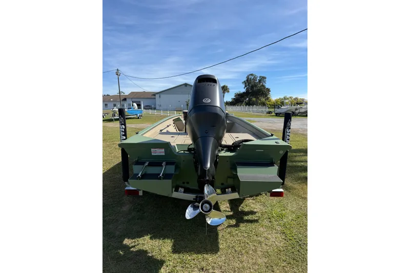 Slide: The Image of 2025 SeaArk Phantom 20XV boat rear view with outboard motor on grass. - 4