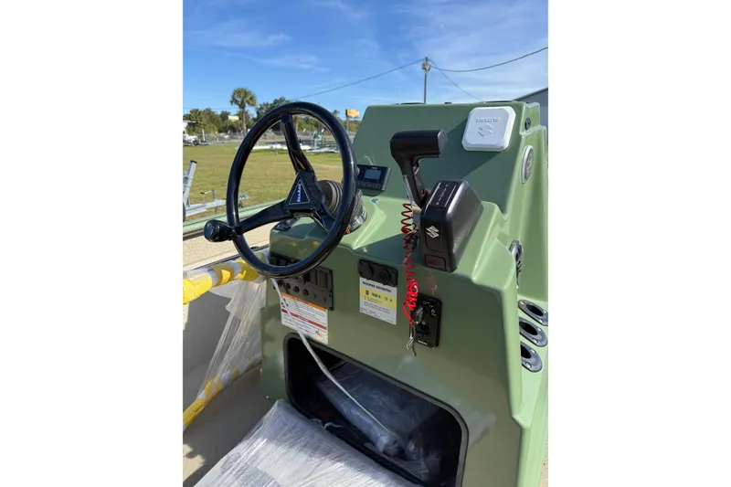 Slide: The Image of 2025 SeaArk Phantom 20XV boat console with steering wheel and controls. - 6