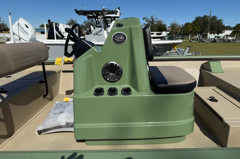 Slide: The Image of 2025 SeaArk Phantom 20XV boat interior with green console and seating. - 7