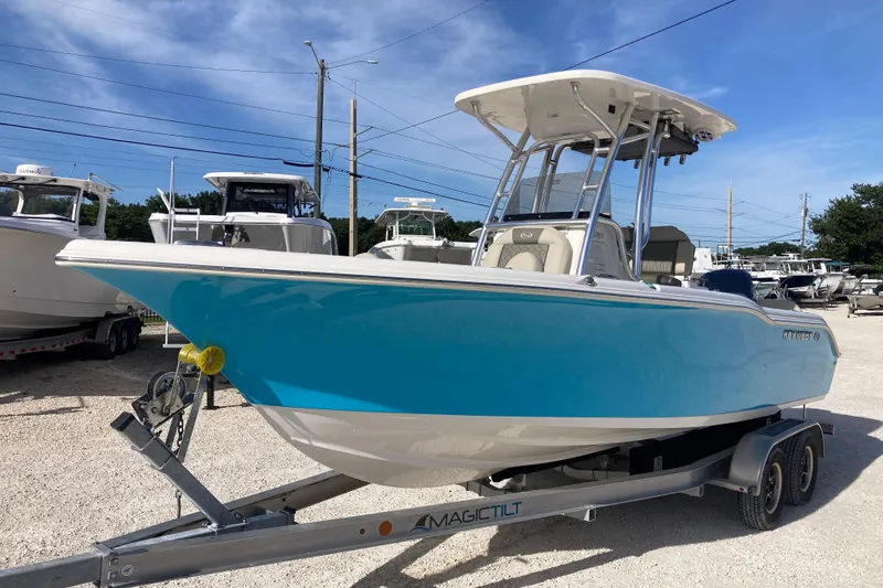 Slide: The Image of 2026 Key West 239 FS boat on trailer, vibrant blue hull, parked outdoors. - 4