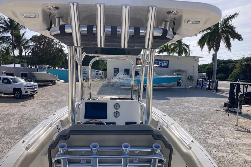 Slide: The Image of 2026 Key West 239 FS boat at marina, featuring modern console and T-top design. - 6