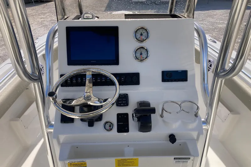 Slide: The Image of 2026 Key West 239 FS boat console with steering wheel, gauges, and electronic controls. - 7