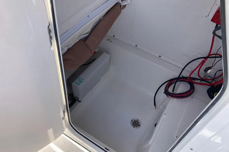 Slide: The Image of Interior compartment of 2026 Key West 239 FS boat with wiring and storage space. - 9