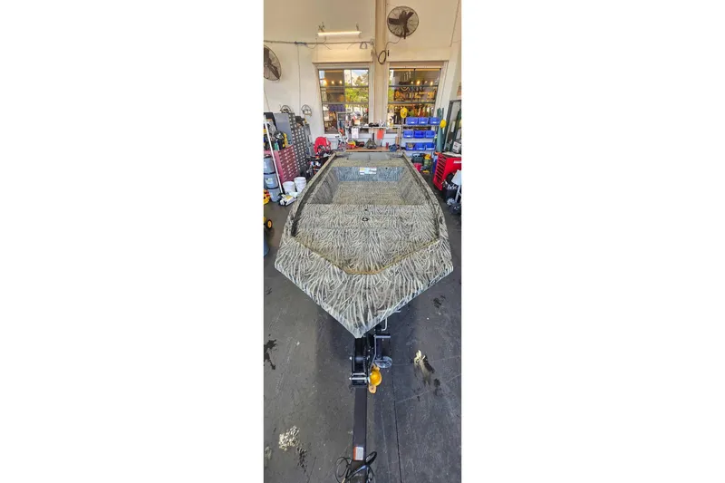 Slide: The Image of 2026 Tracker Grizzly 1648 Utility boat in a workshop setting. - 5