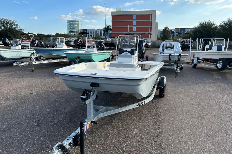 The Image of 2026 Mako Pro Skiff 15 CC boat on trailer in outdoor showroom. - 0