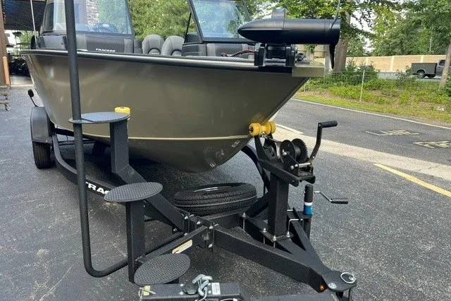 Slide: The Image of 2026 Tracker Targa V-18 Combo boat on trailer, parked outdoors. - 17