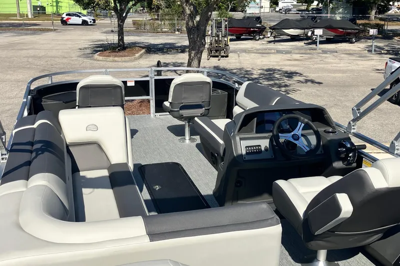 Slide: The Image of 2026 Sun Tracker Fishin' Barge 22 XP3 interior with seating and steering console. - 4