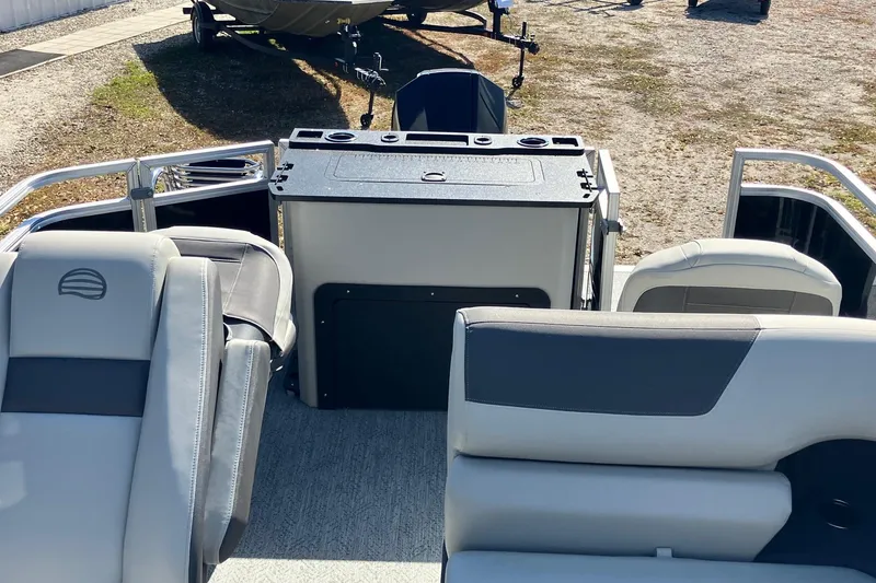 Slide: The Image of 2026 Sun Tracker Fishin' Barge 22 XP3 interior with seating and storage area. - 5