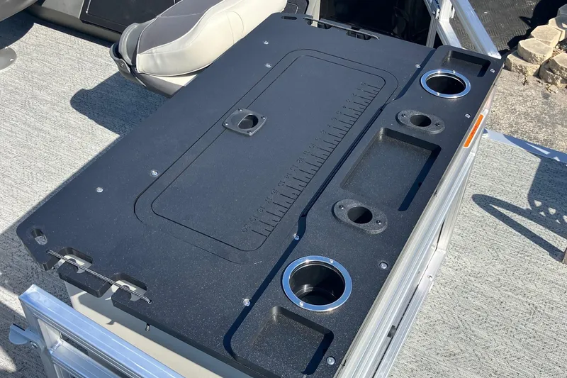 Slide: The Image of 2026 Sun Tracker Fishin' Barge 22 XP3 fishing station with cup holders and storage compartments. - 6