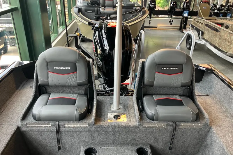 Slide: The Image of 2026 Tracker Pro Guide V-175 Combo boat interior with two gray seats and motor. - 2