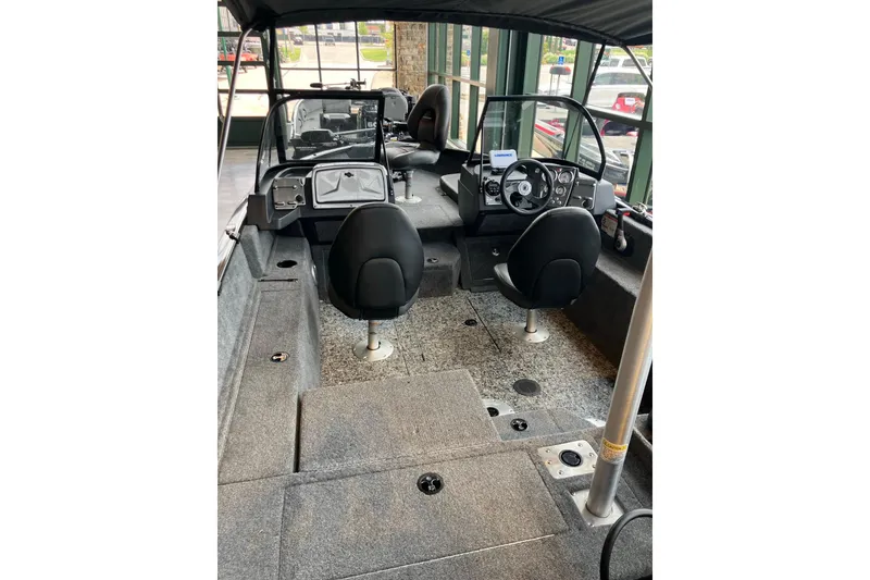 Slide: The Image of Interior of 2026 Tracker Pro Guide V-175 Combo boat with seating and dashboard. - 3