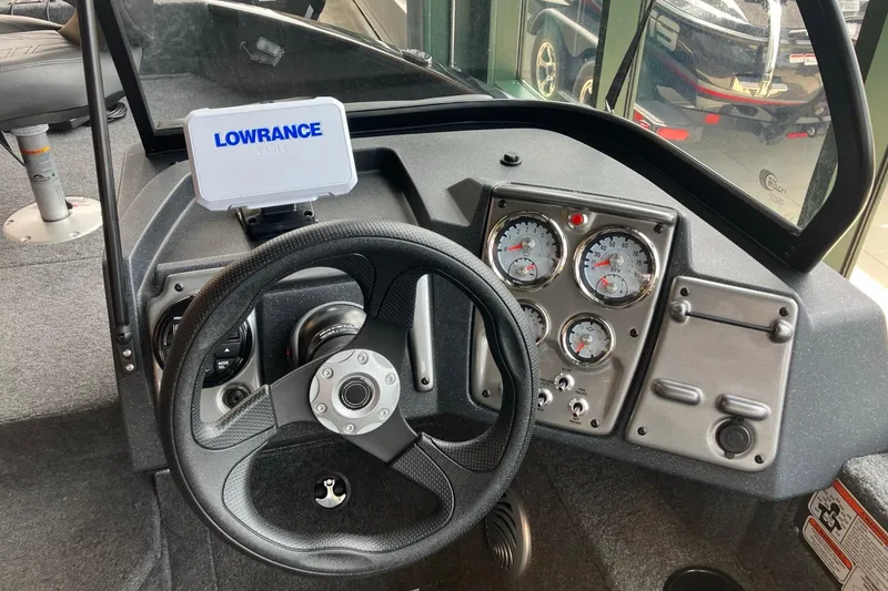 Slide: The Image of 2026 Tracker Pro Guide V-175 Combo boat dashboard with Lowrance display and gauges. - 5