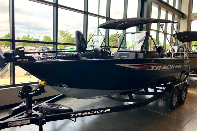 The Image of A 2026 Tracker Pro Guide V-175 Combo boat sits on a trailer in a showroom. - 0