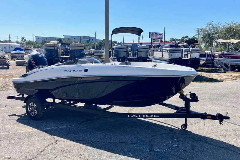 Slide: The Image of 2026 Tahoe T18 boat on trailer in outdoor dealership lot. - 1