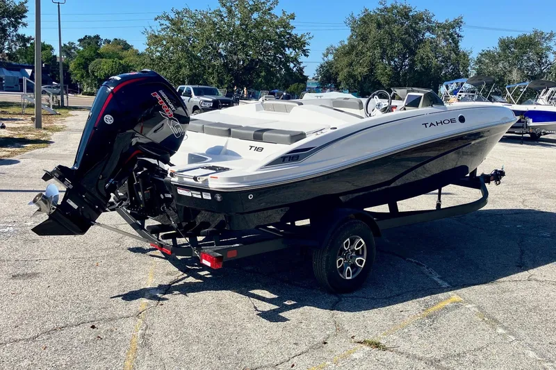 Slide: The Image of 2026 Tahoe T18 boat on trailer with outboard motor in parking lot. - 3