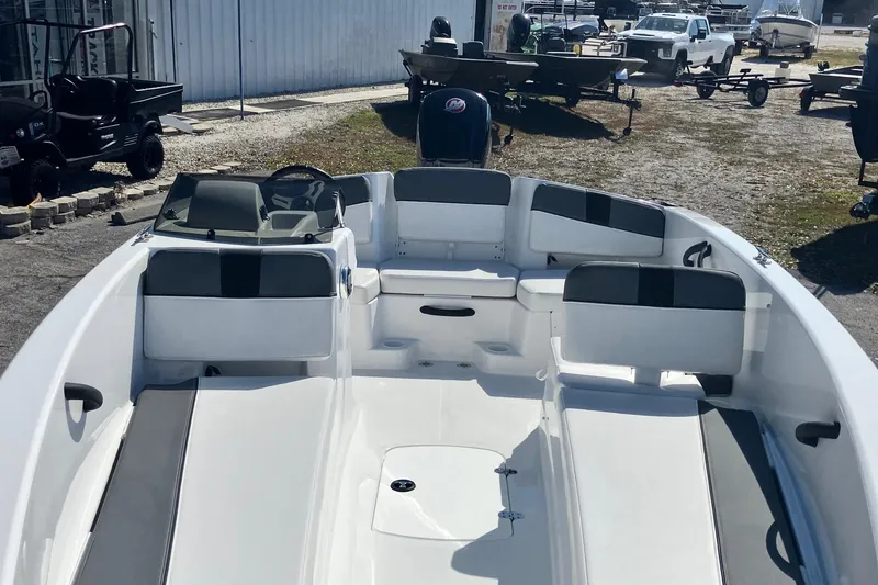 Slide: The Image of 2026 Tahoe T18 boat with spacious seating, parked outdoors in a dealership lot. - 5