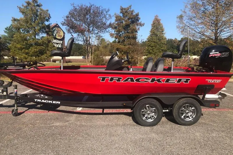 The Image of 2026 Tracker Pro Team 195 boat in vibrant red, parked outdoors on a trailer. - 0