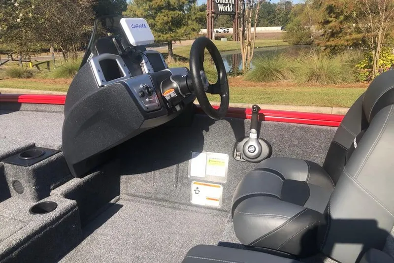 Slide: The Image of 2026 Tracker Pro Team 195 boat interior with steering wheel and seating. - 10
