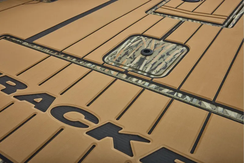 Slide: The Image of 2026 Tracker Grizzly 1756 T Marsh boat interior with camouflage design and tan flooring. - 15