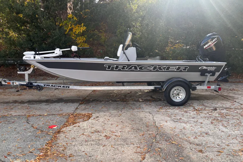 The Image of 2026 Tracker Bass Tracker Classic CC boat on trailer, parked outdoors. - 0