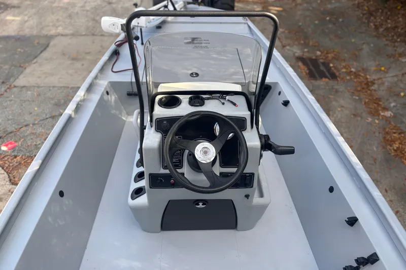 Slide: The Image of 2026 Tracker Bass Tracker Classic CC boat interior with steering console and controls. - 2