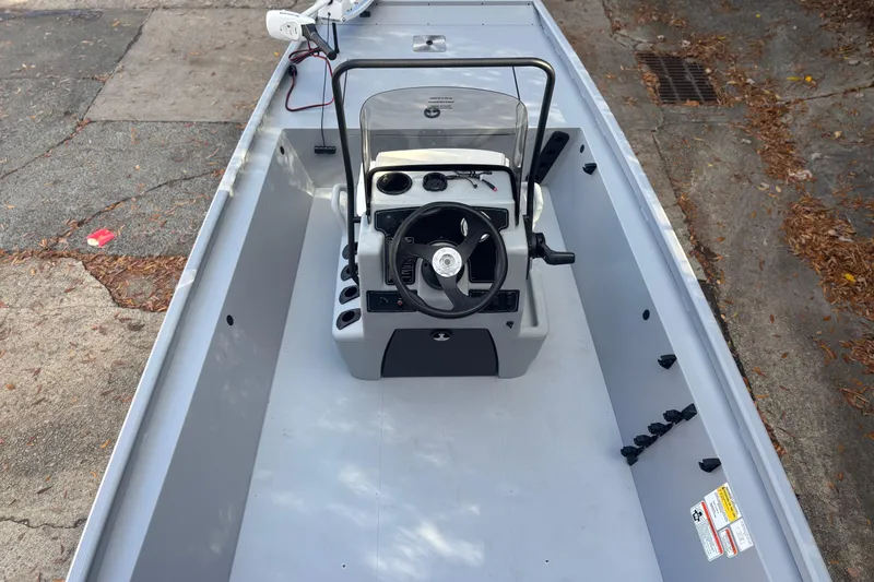 Slide: The Image of 2026 Tracker Bass Tracker Classic CC boat interior with steering console and clean deck. - 3