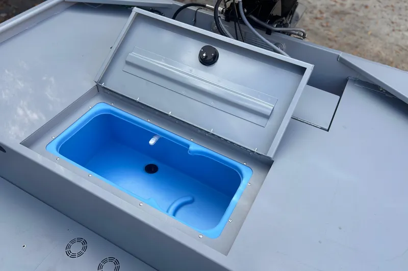 Slide: The Image of Open storage compartment on 2026 Tracker Bass Tracker Classic CC boat, featuring a blue interior. - 8