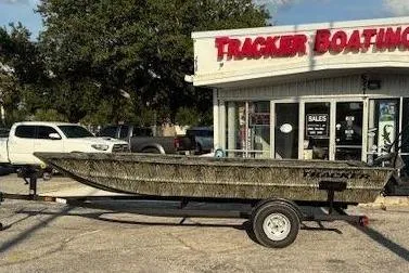 The Image of 2026 Tracker Grizzly 1754 Utility boat on trailer outside Tracker Boating store. - 0
