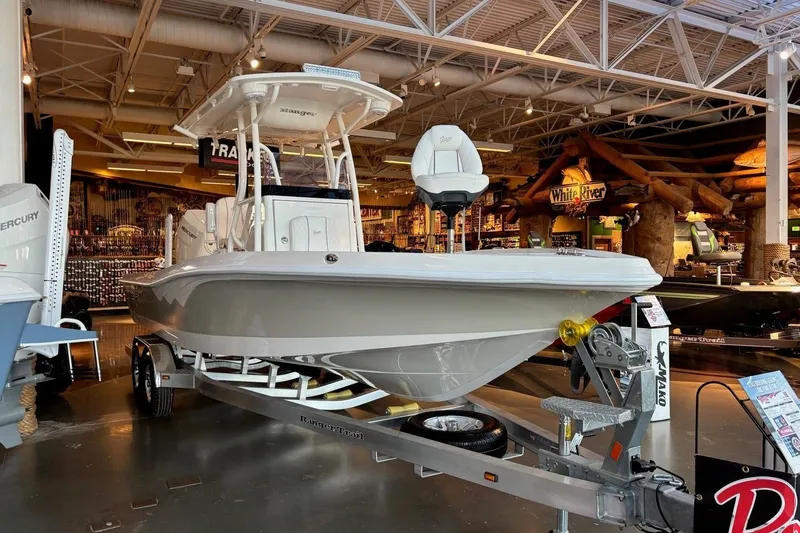 Slide: The Image of 2026 Ranger 2510 Bay boat displayed indoors on a trailer. - 3