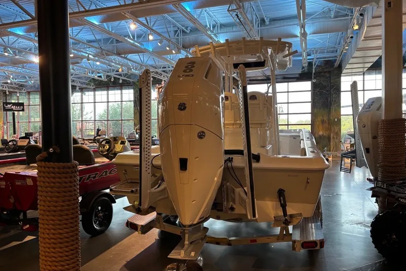 Slide: The Image of 2026 Ranger 2510 Bay boat displayed in a showroom with modern lighting. - 11