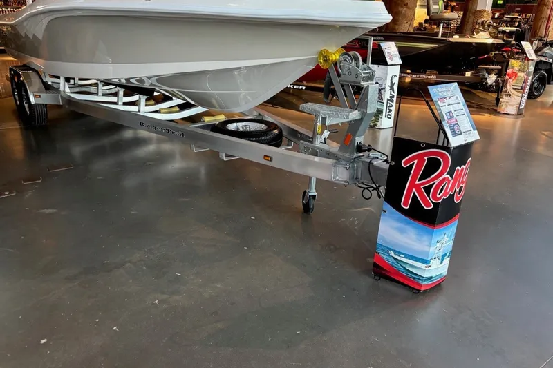 Slide: The Image of 2026 Ranger 2510 Bay boat on display with trailer in showroom. - 9