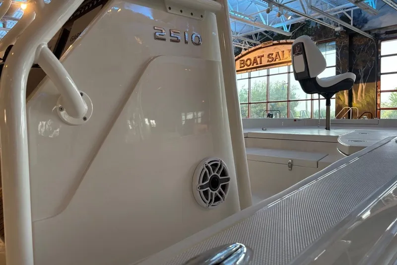 Slide: The Image of 2026 Ranger 2510 Bay boat interior at a showroom with seating and speaker detail. - 13