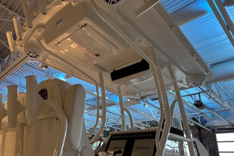 Slide: The Image of 2026 Ranger 2510 Bay boat interior with advanced Garmin navigation system and overhead rod holders. - 12