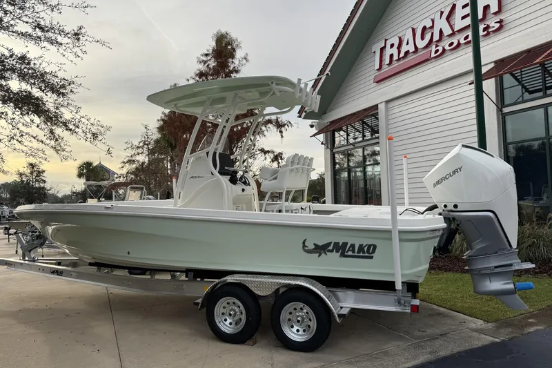 The Image of 2026 Mako 24 APEX boat on trailer outside Tracker Boats dealership. - 0