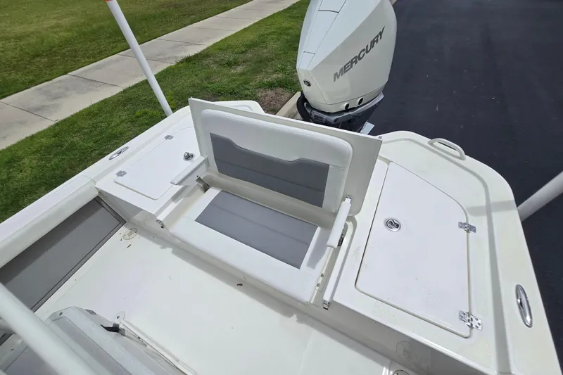 Slide: The Image of 2026 Mako 24 APEX boat with Mercury engine, featuring a foldable seat and storage compartments. - 6