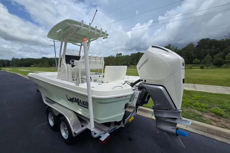 Slide: The Image of 2026 Mako 24 APEX boat on trailer with Mercury outboard engine. - 1