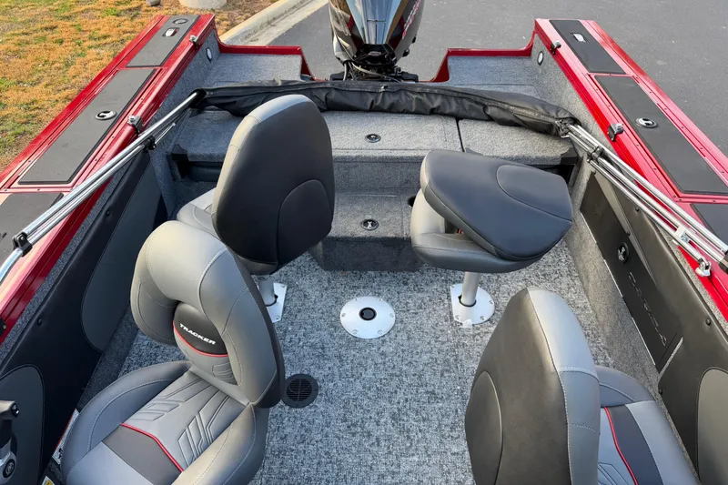 Slide: The Image of 2026 Tracker Targa V-19 Combo boat interior with gray and red seating, carpeted floor. - 5